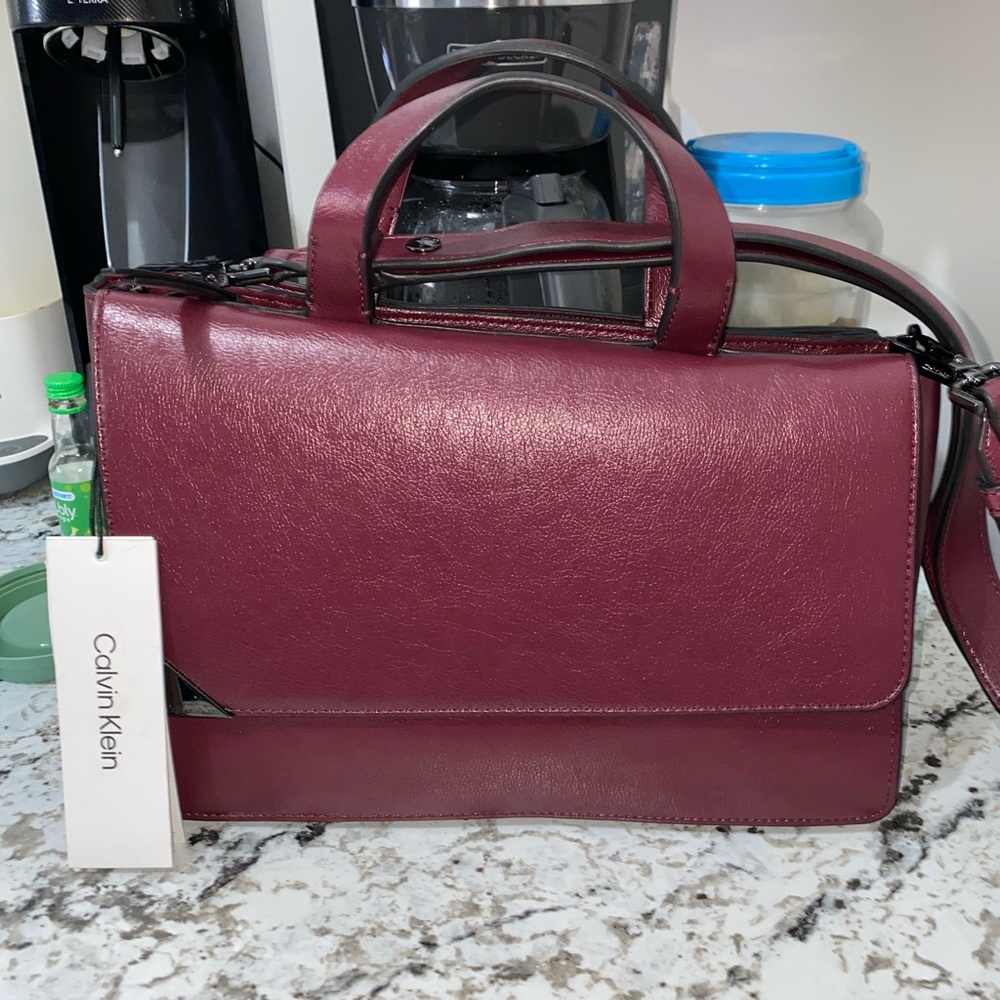 BRAND NEW, never used. Calvin Klein beautiful womens bag. Maroon color.